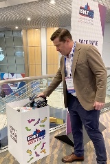 Photo of Dan Dilling donating socks to the ISHLT2023 Sock Drive in Denver.