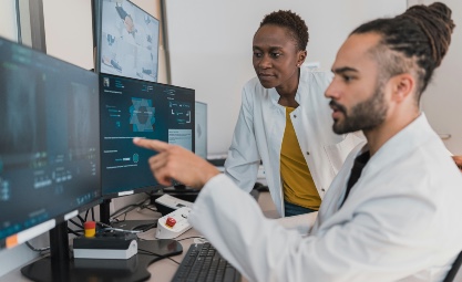 Photo of medical professionals looking at a computer