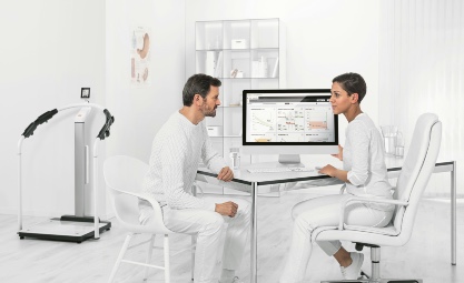 Photo of medical professionals looking at a computer