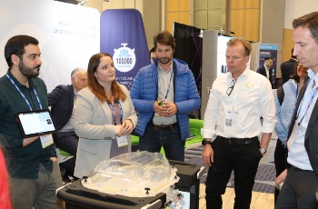 People standing in a group at an ISHLT2023 Exhibit Booth