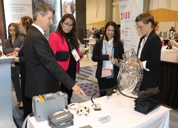 Man pointing at a device in the ISHLT2023 Exhibit Hall