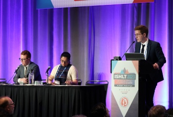 Man standing at a podium to present at ISHLT2023