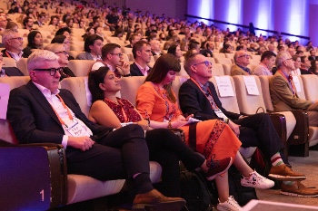 Photo of four people sitting watching ISHLT2024 presentations