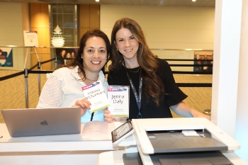 Photo of two women picking up ISHLT2023 Badges