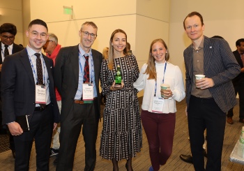 Photo of five people smiling