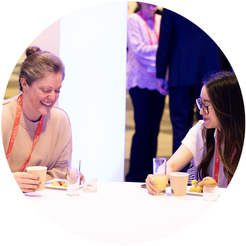 Photo of two women sitting at the ISHLT2024 First-Time Attendee Breakfast