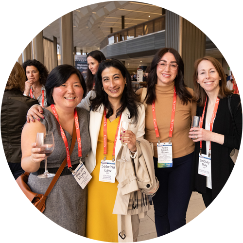 Four women smiling and holding drinks during ISHLT2024 Opening Reception