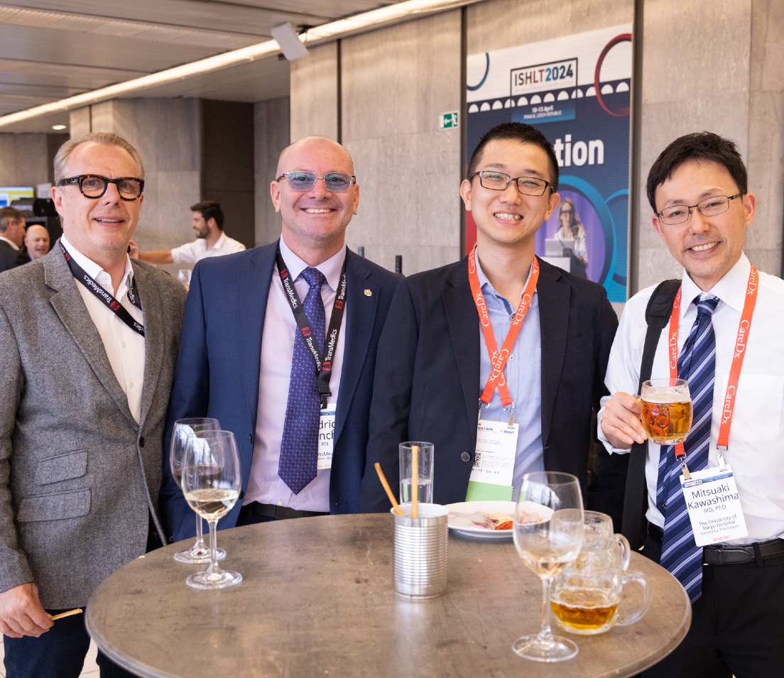 Photo of four men smiling at ISHLT2024 in Prague