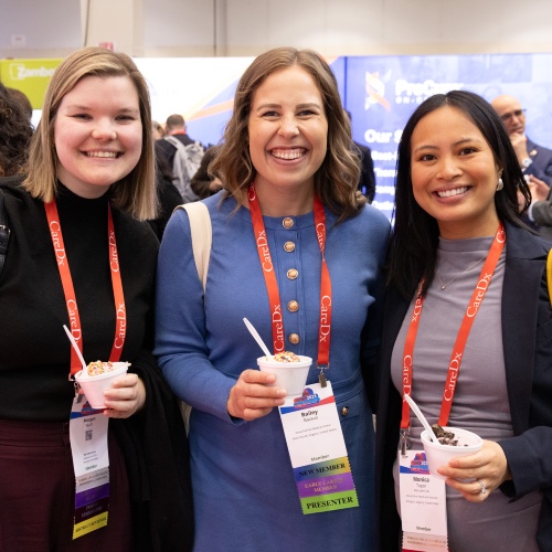 ISHLT2026_OpeningReception Three women smiling in the exhibit hall